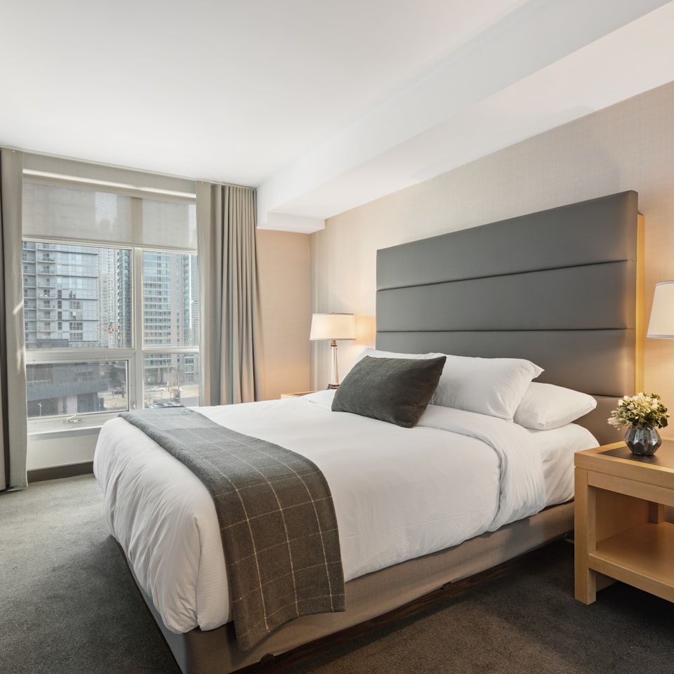 Professionally made hotel bed with crisp white linens